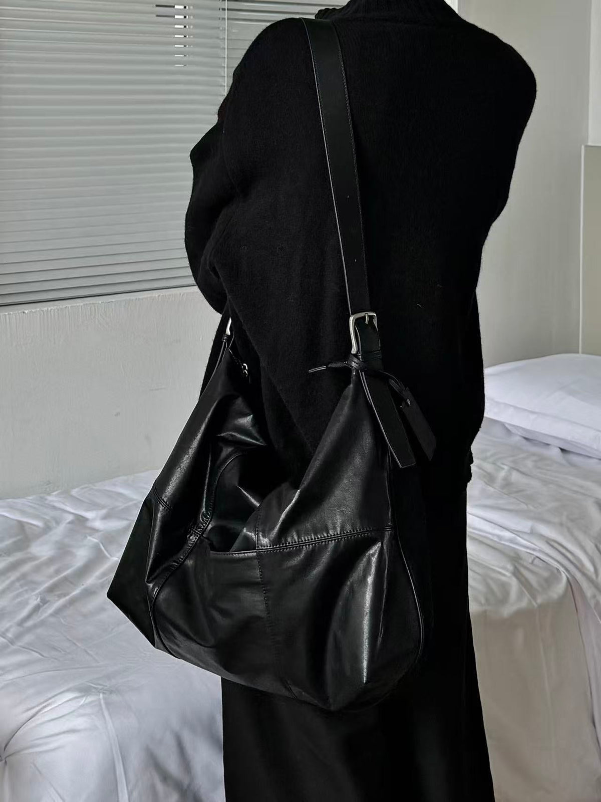 ARCcc segmented 16-inch black PU crossbody bag worn over shoulder